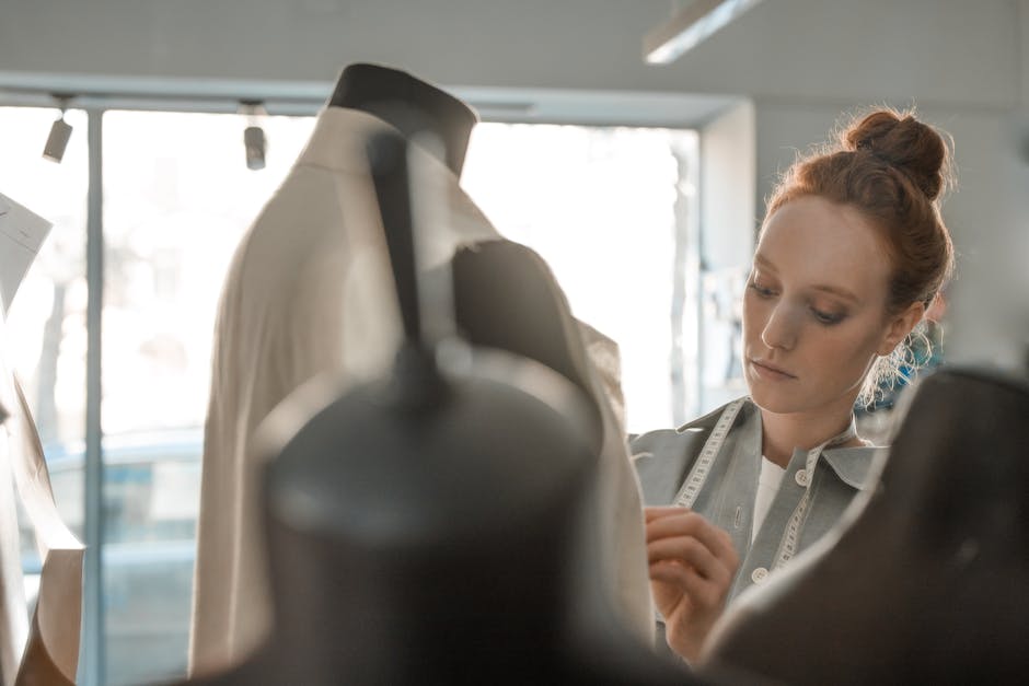 A fashion designer skillfully working with a mannequin and tape measure, focused on details.
